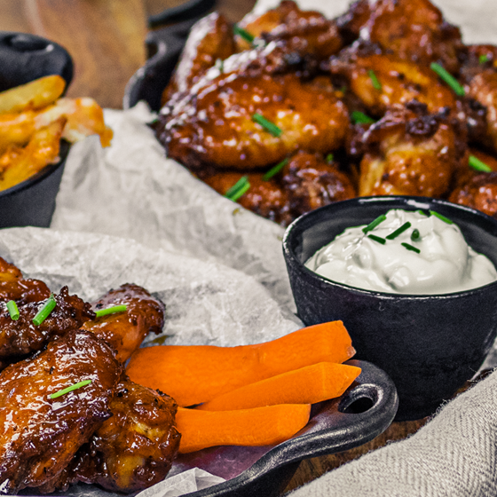 plate of wings with ranch and fries on the site